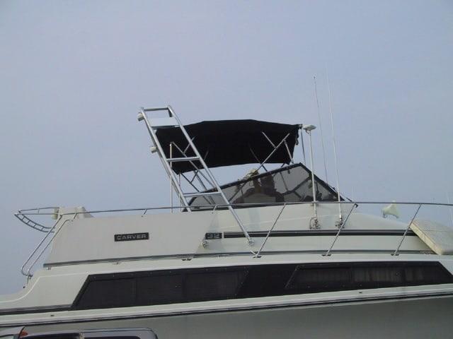 Carver 32 Mariner boat showing the installed Atlantic Towers arch with a black canopy and railing details.