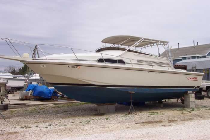 Atlantic Towers Top installed on a Boston Whaler boat, viewed from the side on a trailer in a marina.