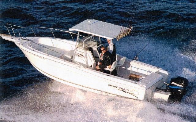 Atlantic Towers T-Top installed on a white Hydra Sports 2200 Center Console boat cruising on the water with two passengers.