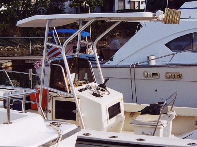 Atlantic Towers T-Top installed on Parker Center Console boat showing helm and steering wheel docked by water