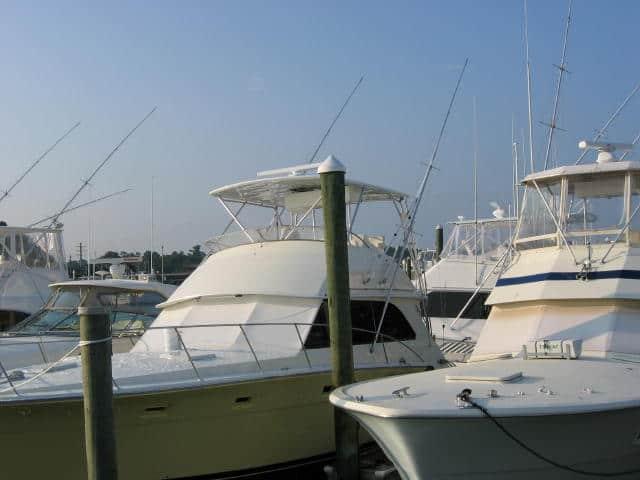 Atlantic Towers Top installed on Bertram 46.6 Convertible boat docked alongside other boats in a marina.