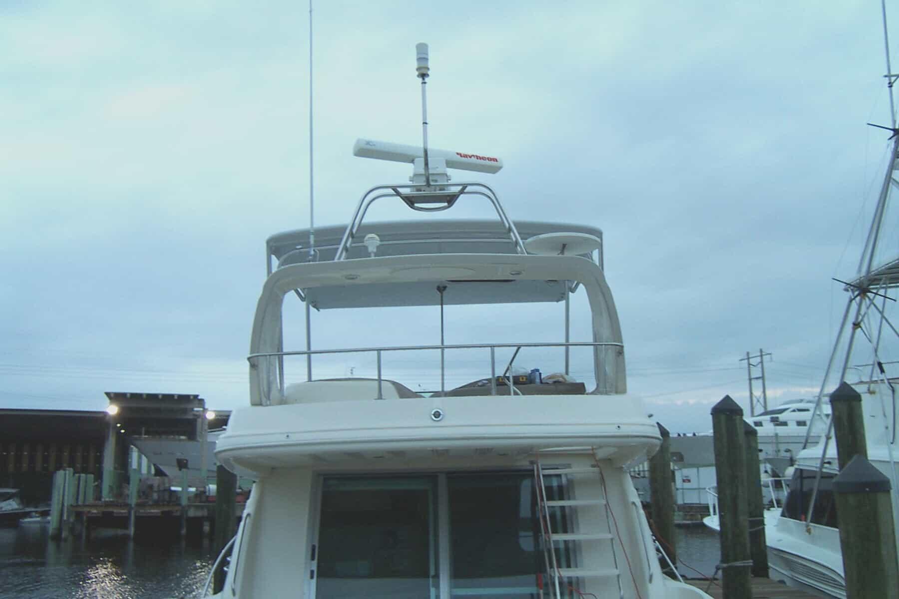 Atlantic Towers top installed on a Maxum 46 SCB boat, with a view of the marina in the background.