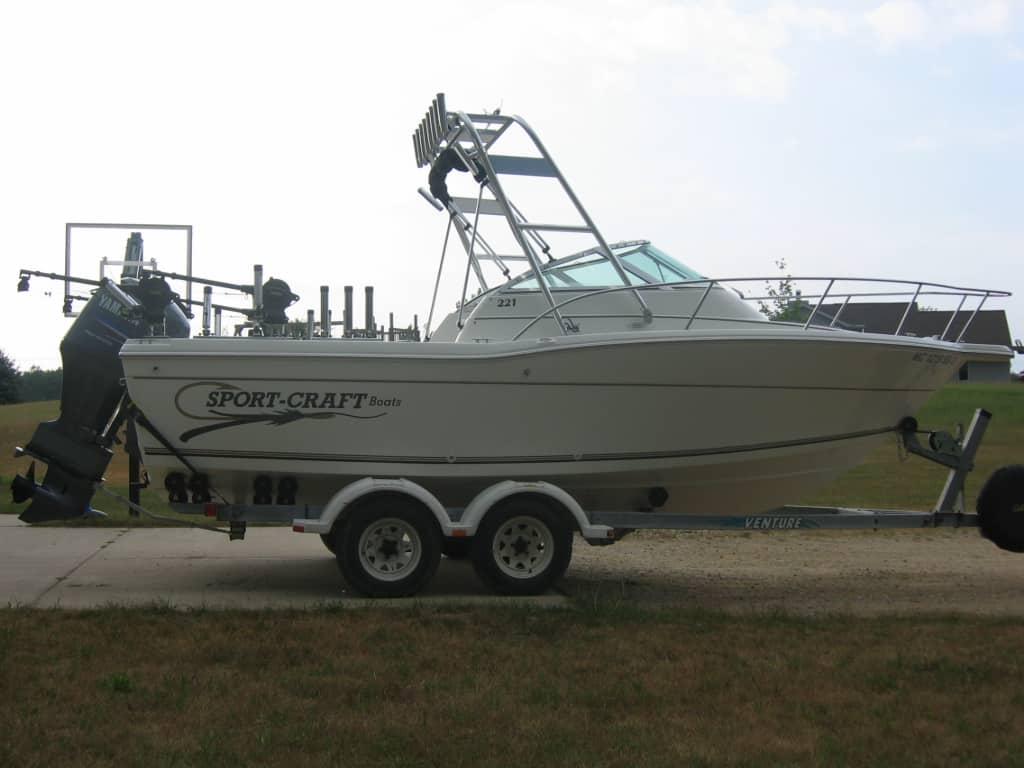 Sportcraft 221 W/A boat on trailer equipped with Atlantic Towers arch and Yamaha outboard motor.