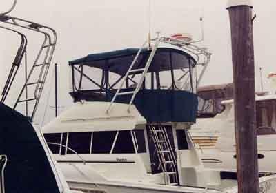 Atlantic Towers Arch installed on a Silverton 41 Convertible boat, with a blue canvas top and nearby docking structures.