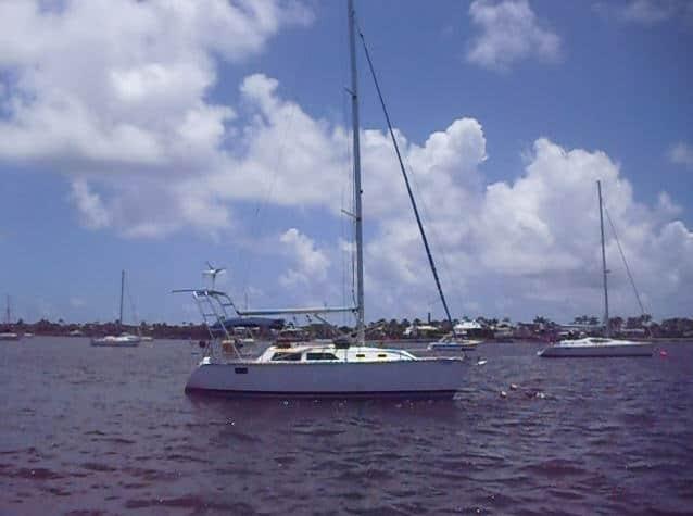 Atlantic Towers Arch installed on a Hunter 30 sailboat, showing the curved frame above the cockpit against a blue sky.