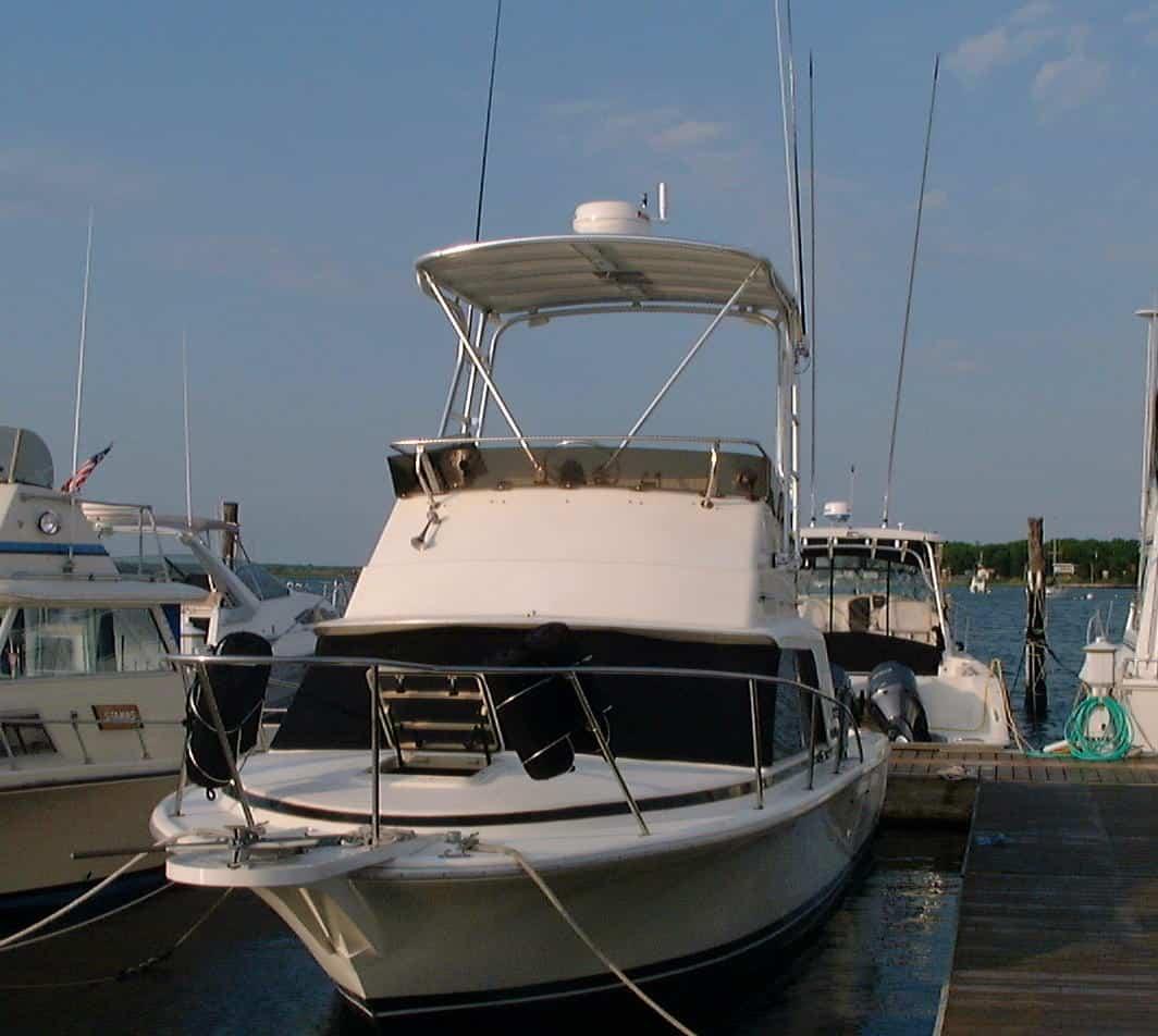 Front view of Phoenix 29 Convertible boat docked, featuring Atlantic Towers Top installed on the upper deck.