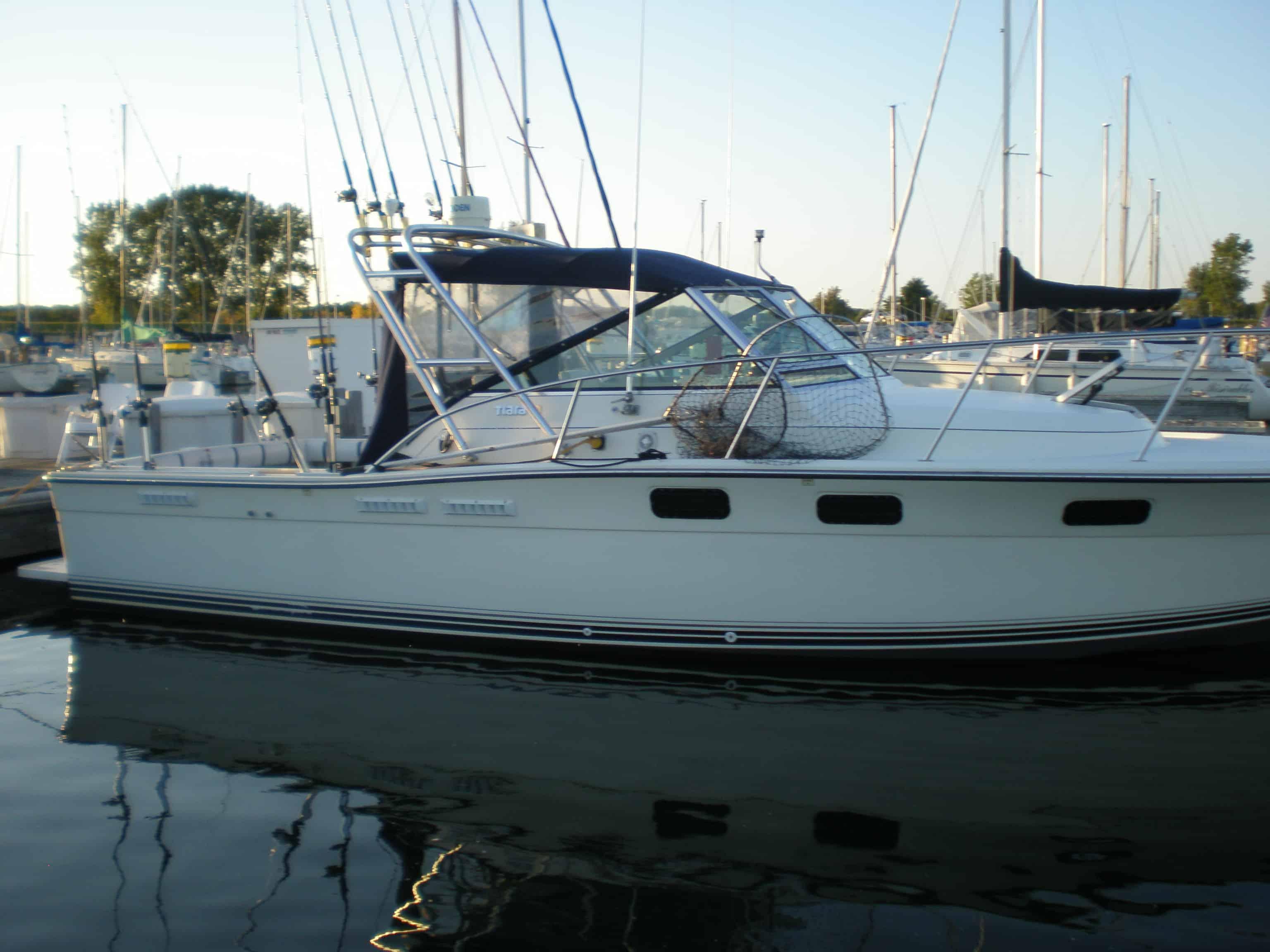 Atlantic Towers Arch installed on a Pursuit 2700 Open boat docked at a marina during sunset.