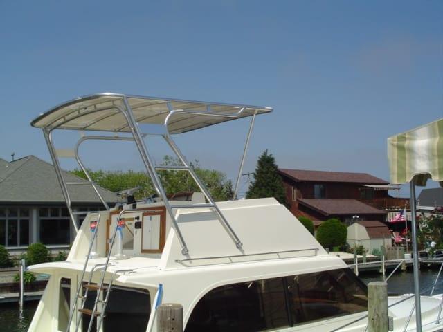 Atlantic Towers Top installed on an Egg Harbor 33 FB boat, docked with buildings in the background.