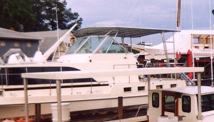 Atlantic Towers Top installed on a Bertram motoryacht docked at a marina, showcasing the boat's sleek design.