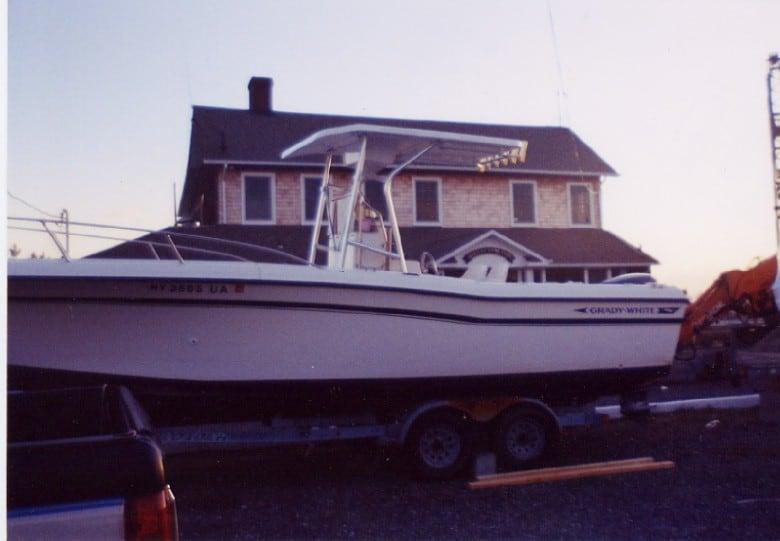 Atlantic Towers T-Top installed on a Grady White 249 Fisherman boat, parked near a house at sunset.