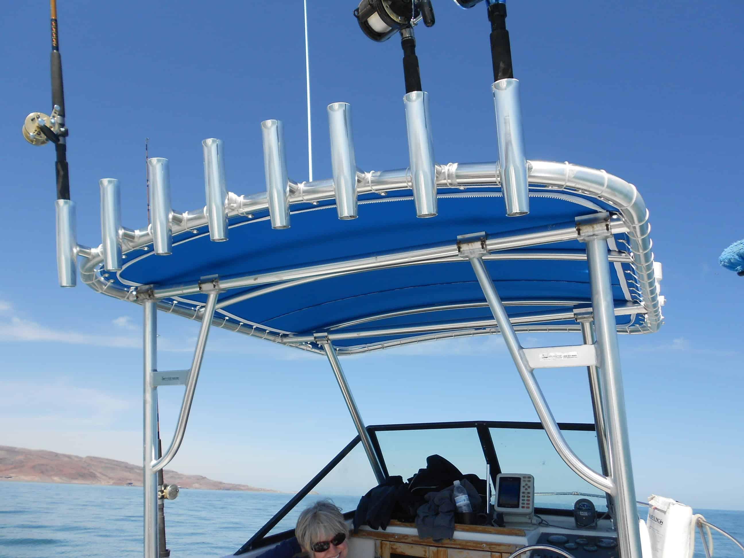 Atlantic Towers Top installed on an Invader 245 walkaround boat displayed on water near a marina.