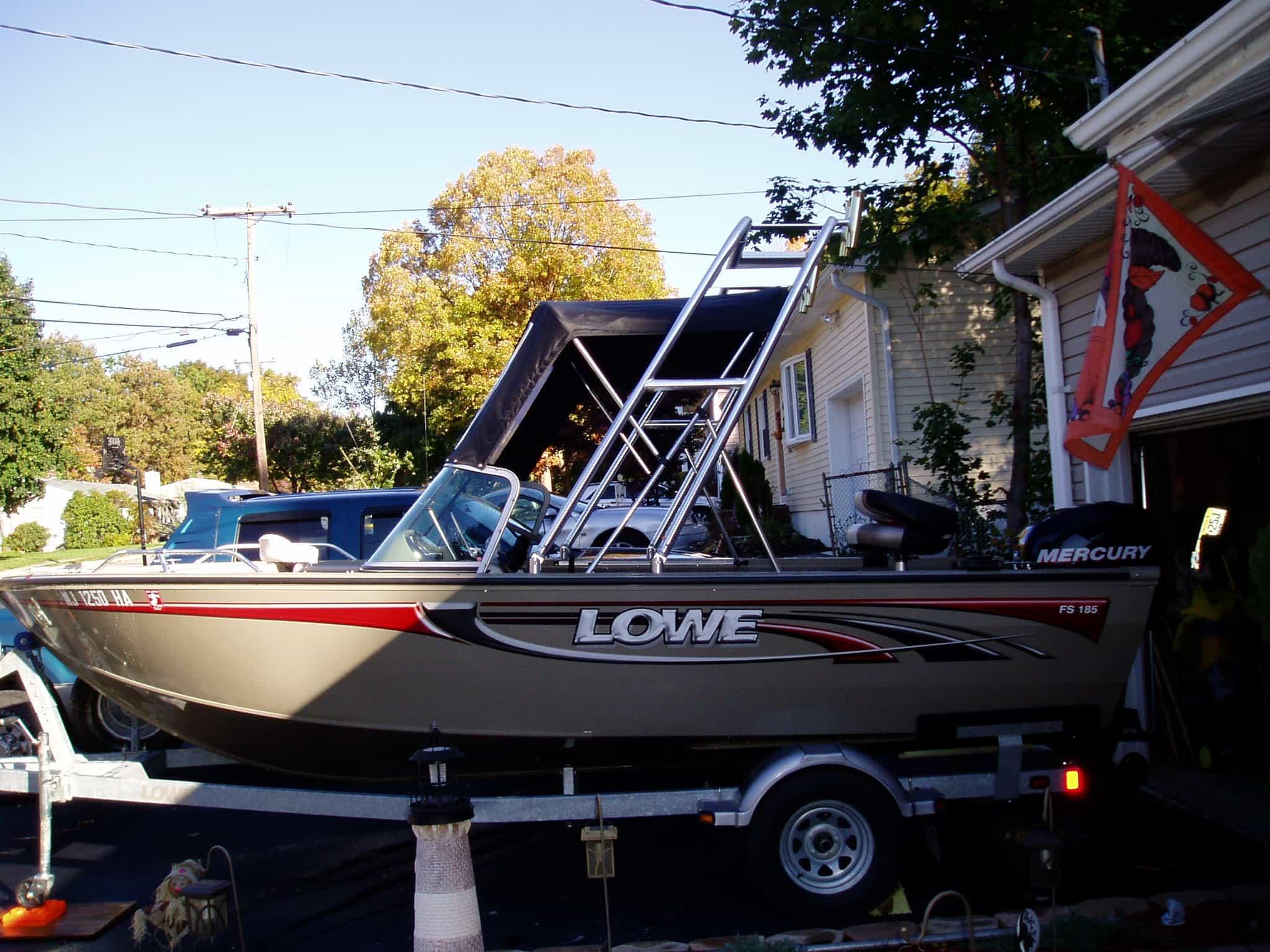 Atlantic Towers Arch installed on a Lowe SKI & FISH boat parked in a residential area.