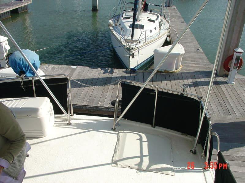 Atlantic Towers Aft Deck Top installed on Silverton aft cabin boat with dock and sailboat in background.