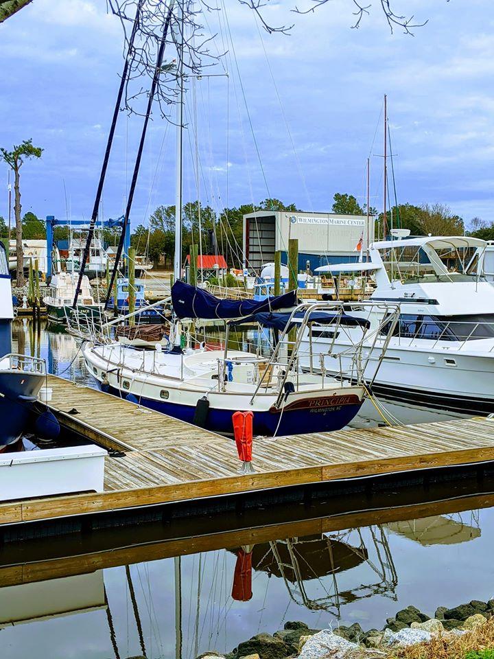 Atlantic Towers Arch installed on a sailboat docked at a marina with reflections in the water.
