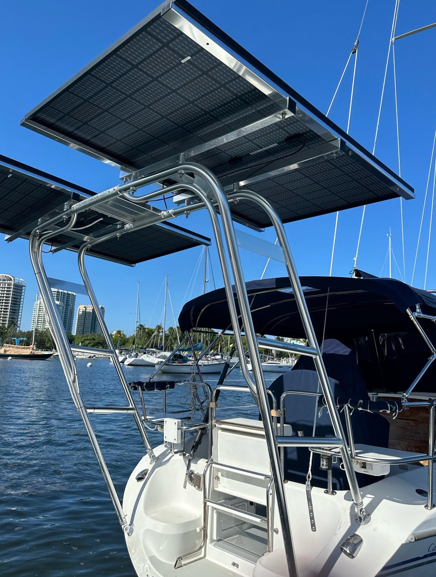 Atlantic Towers Arch installed on a Catalina boat, featuring solar panels above a metal frame on the water.