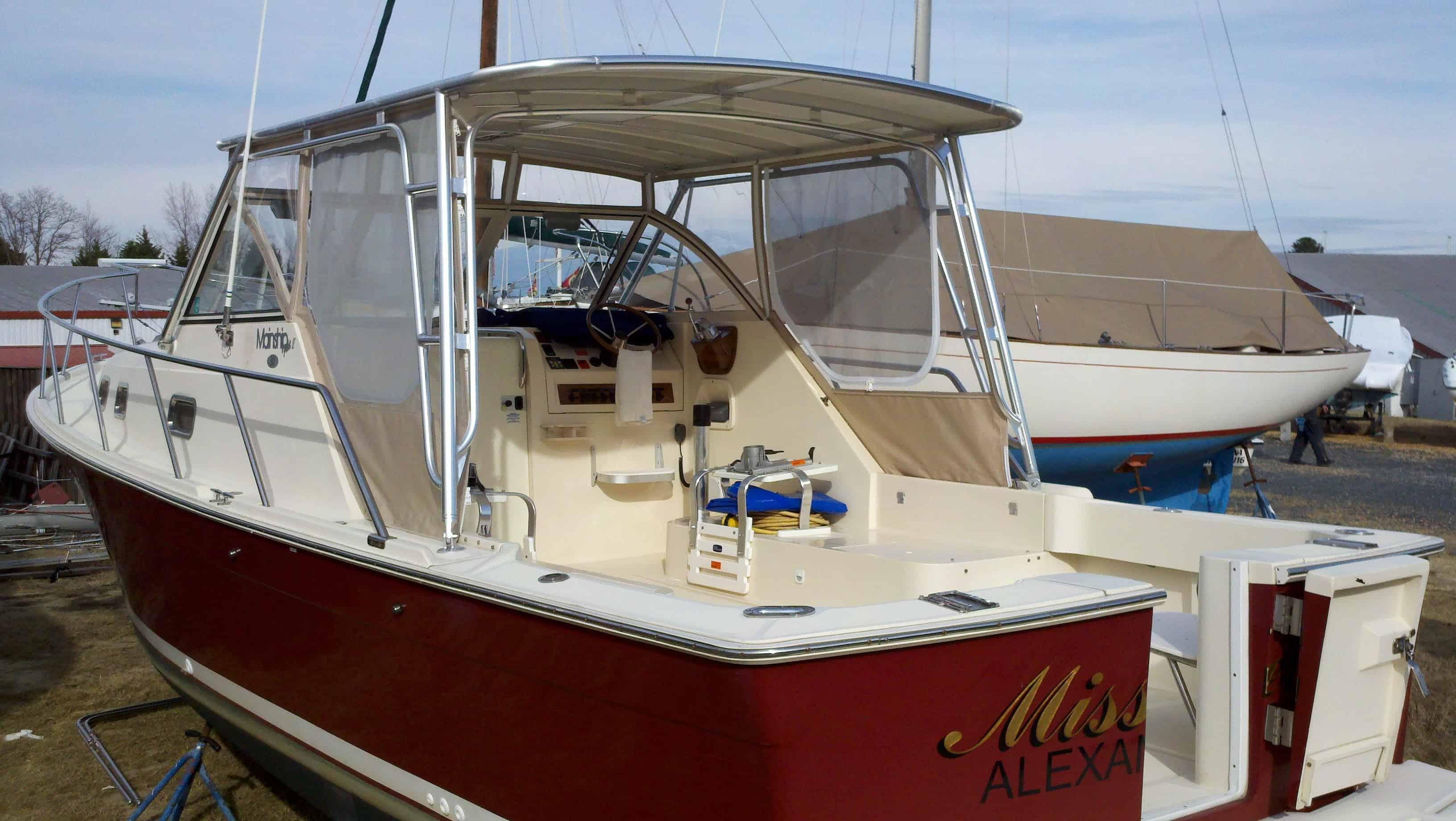 Atlantic Towers Top installed on a Mainship 30 Pilot cruiser boat docked by a marina on a sunny day