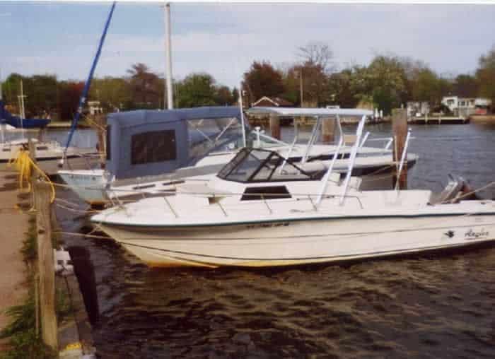 Atlantic Towers Top installed on an Angler boat docked on a lake, surrounded by other boats and trees.