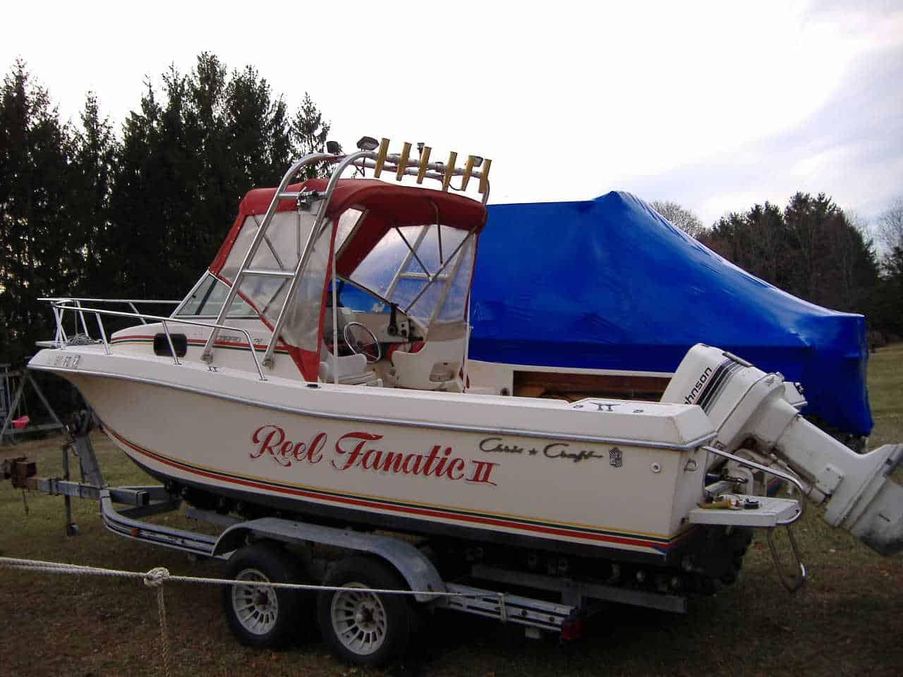 Atlantic Towers Arch on a Chris Craft 21 Sea Hawk boat, showcasing the vessel parked on a trailer in a grassy area.