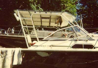 Atlantic Towers top installed on a Boston Whaler 27 Walkaround boat, showcasing its structure amid greenery.