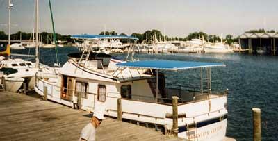 Atlantic Towers Aft Deck Top installed on Defever Yachts 43 Trawler docked at marina with other boats nearby.