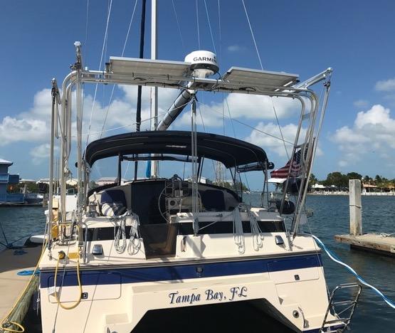 Atlantic Towers Arch installed on a boat docked in Tampa Bay, featuring a bimini top and electronics.