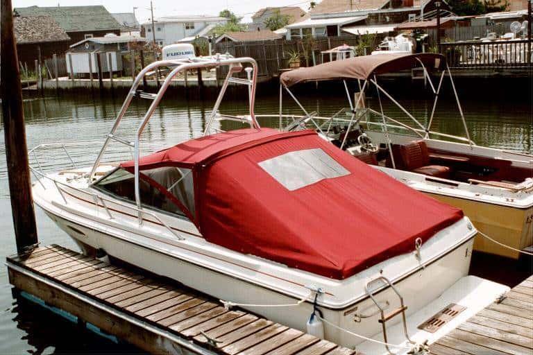 Atlantic Towers Air Tower installed on a Sea Ray 210 Sorrento boat with a red cover, docked at a marina.