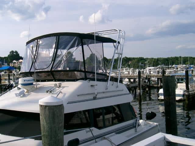 Atlantic Towers Arch installed on a Silverton 34 C boat at a marina, with docks and other boats in the background.