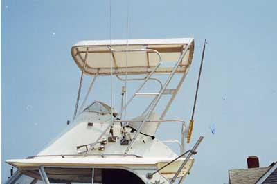 Atlantic Towers Top installed on a Bertram 31 Flybridge Cruiser, showcasing its design against a clear blue sky.