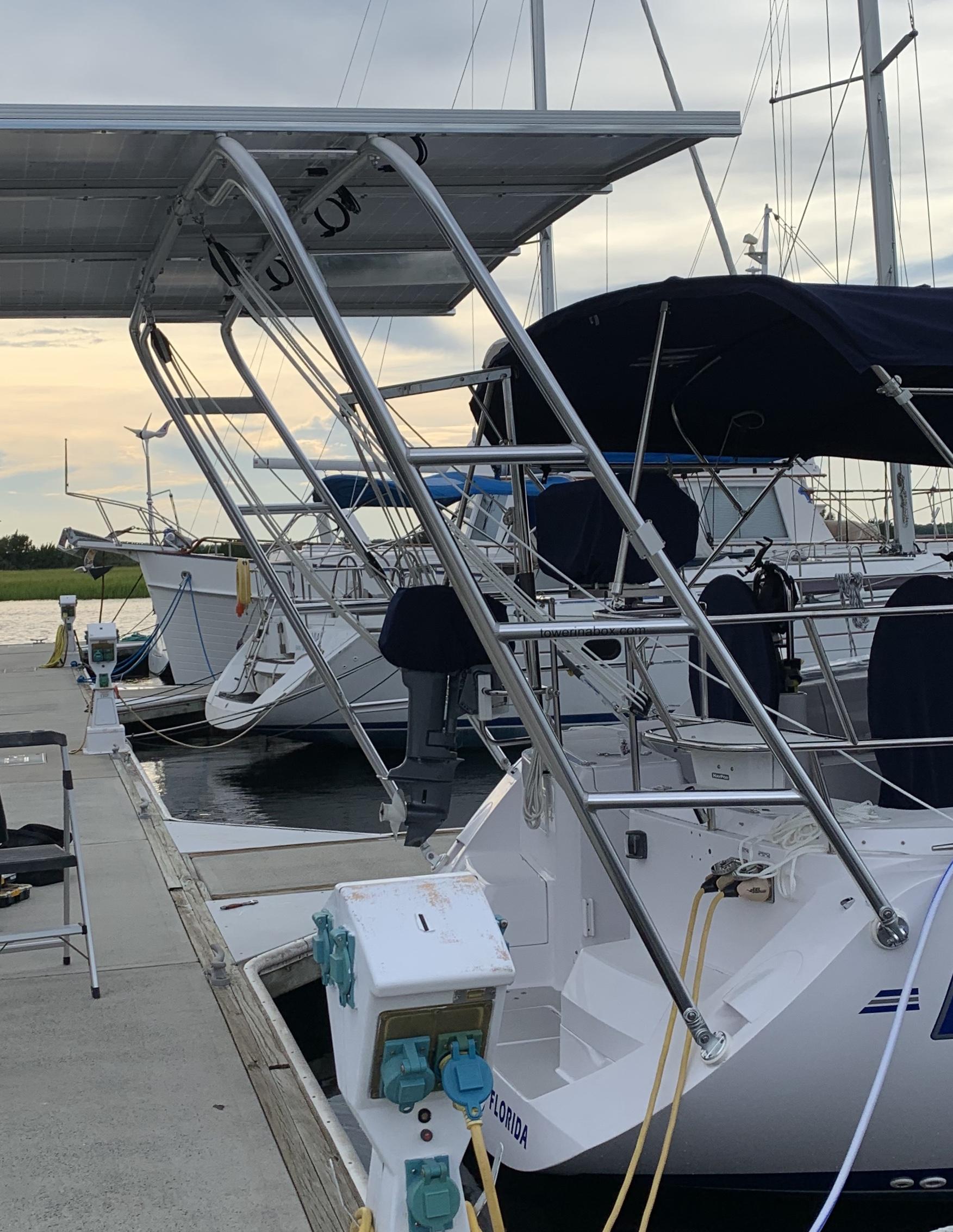 Atlantic Towers Arch installed on a boat at the marina, featuring a solar panel and adjacent vessels.
