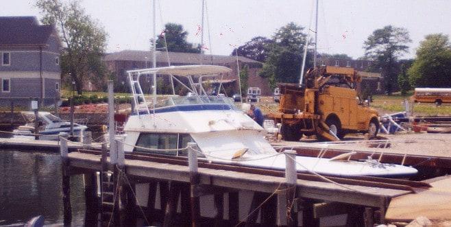 Atlantic Towers Top installed on a Hatteras 42 Convertible boat docked at a marina.