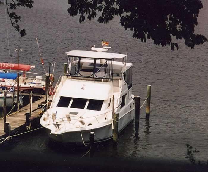 Atlantic Towers Top installed on a Silverton 392 boat docked at a waterfront, surrounded by other vessels.
