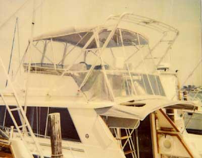 Atlantic Towers Arch installed on the upper deck of a Silverton 40 Convertible boat docked at a marina.