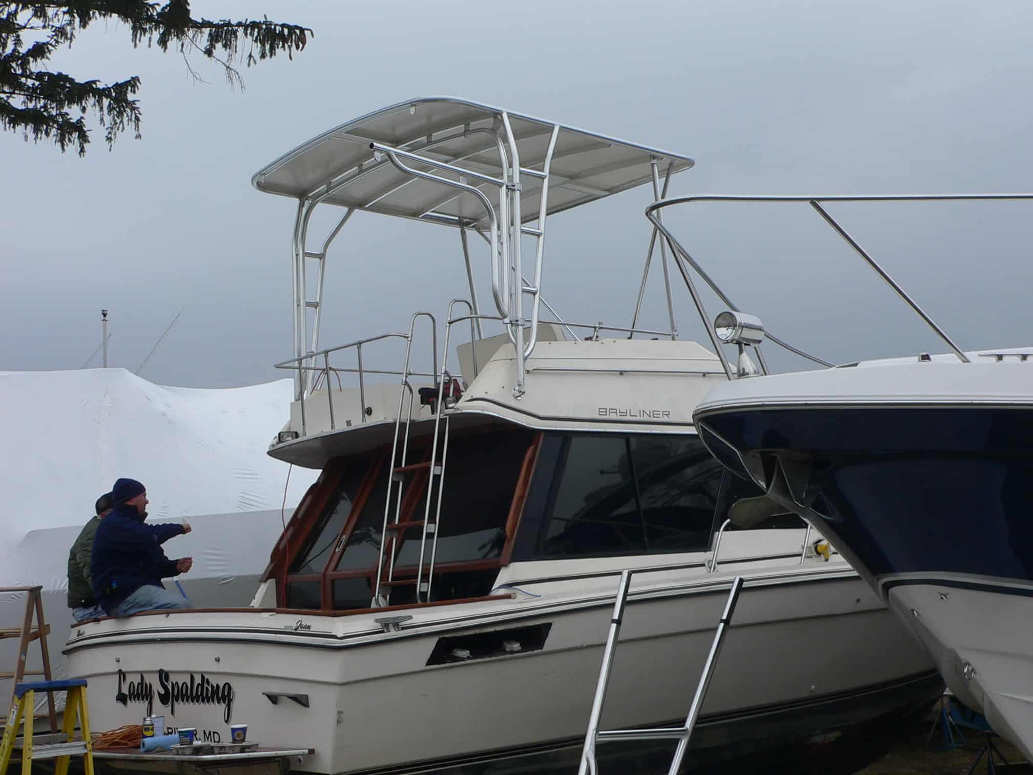 Atlantic Towers Top installed on a Bayliner 3250 Sedan Bridge boat, with crew members working nearby.