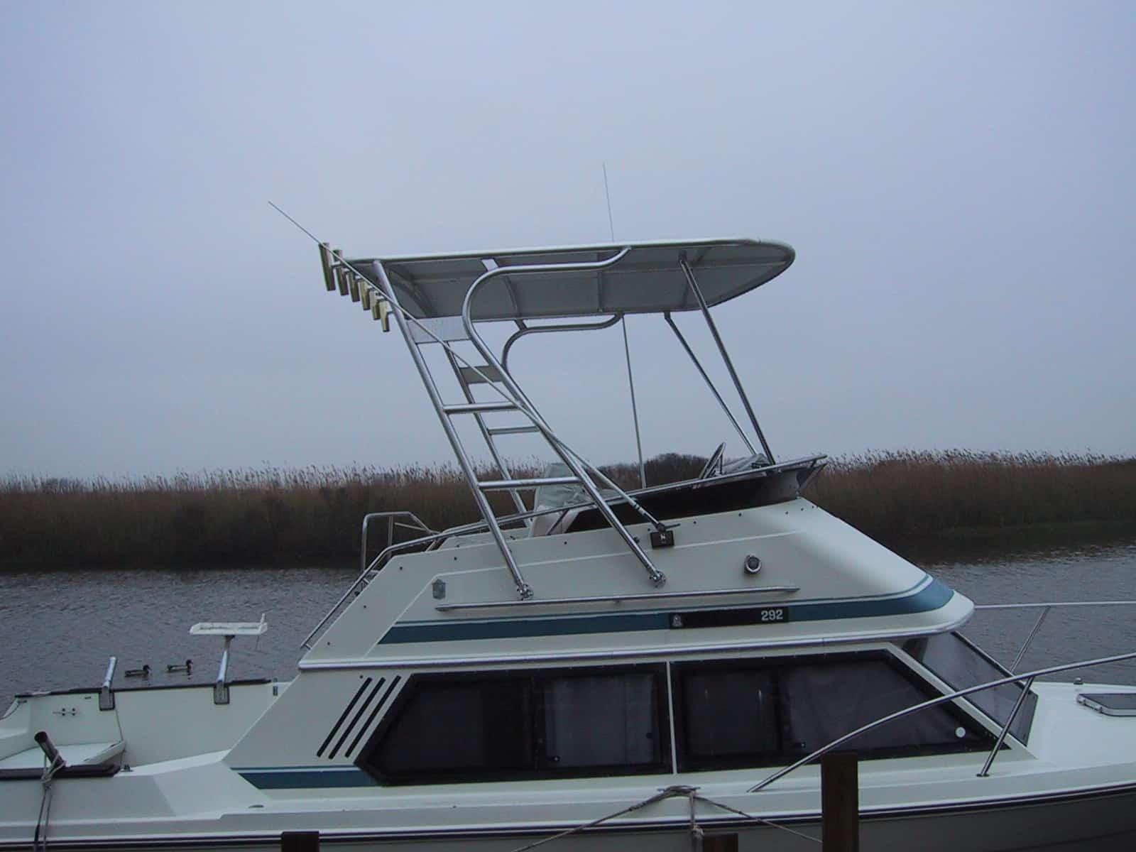 Atlantic Towers Top installed on a Chris Craft 292 boat, docked near a river with a cloudy sky.