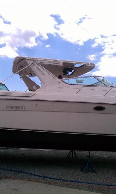 Atlantic Towers Top installed on a Regal 380/400/402 Commodore express boat, shown from the side on water