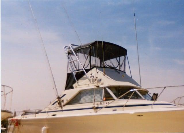 Chris Craft 31 Commander boat equipped with an Atlantic Towers Arch and a black canopy over the helm area.