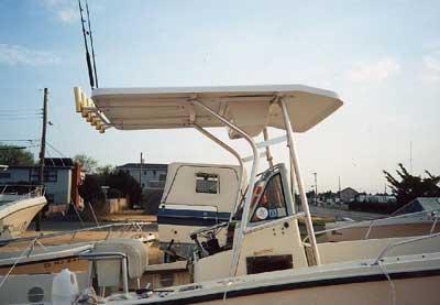 Atlantic Towers T-Top installed on a Mako 254 Console boat, overlooking a marina with parked boats.