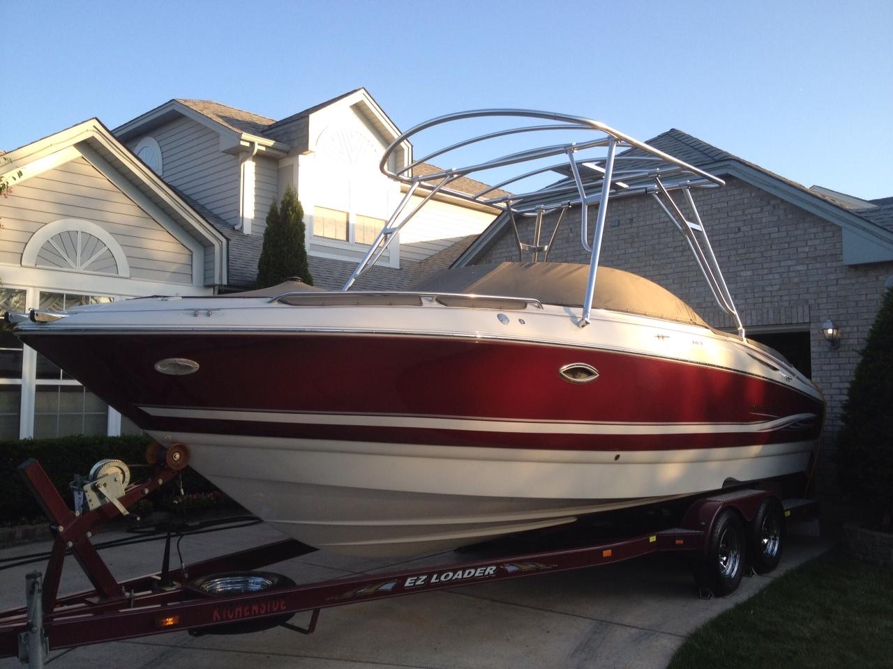 Atlantic Towers Top installed on a Monterey 248 LS boat, parked in a driveway with houses in the background.