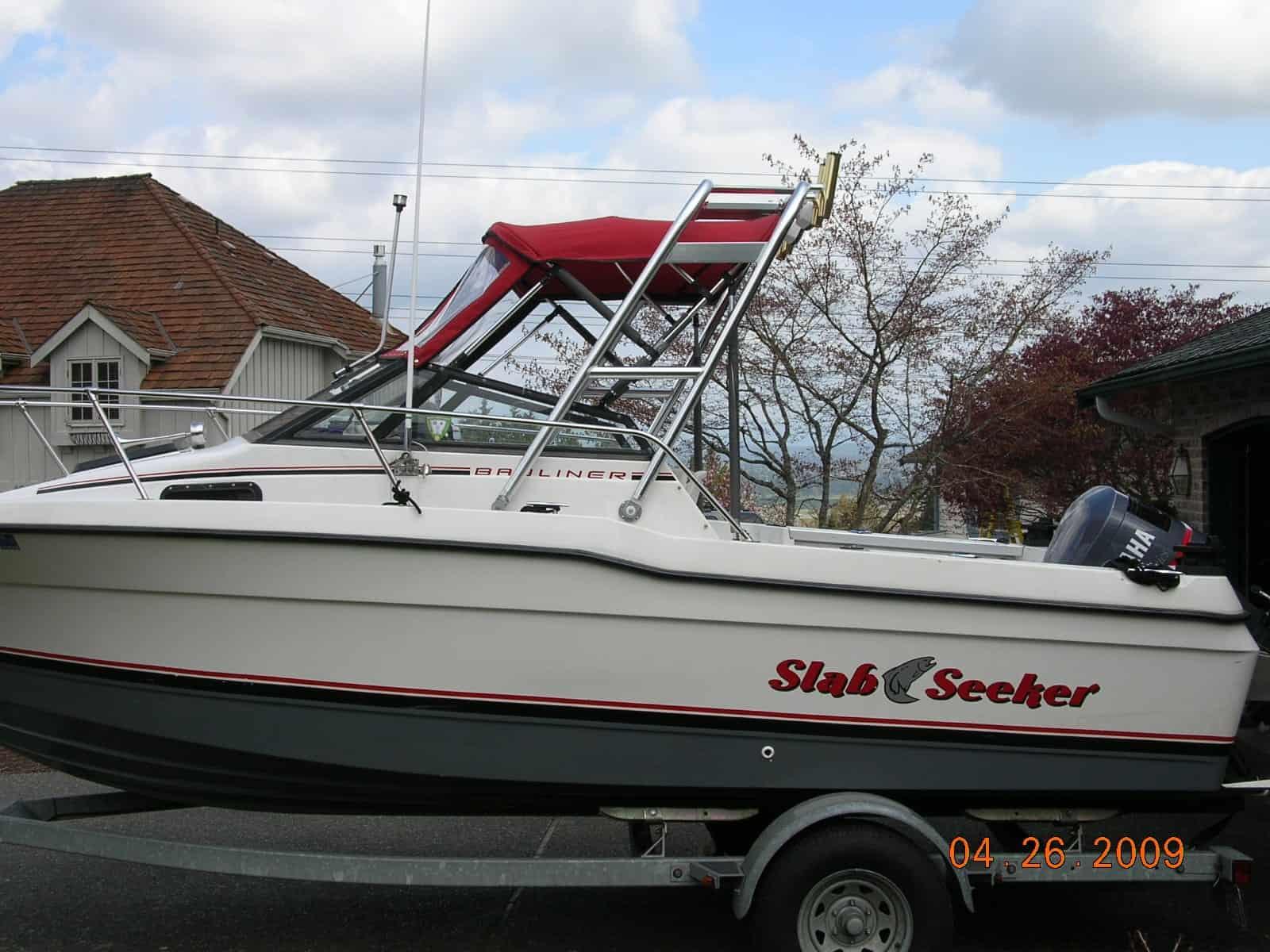 Trophy 2002 Walkaround boat on a trailer with a red Atlantic Towers Arch mounted above the cockpit area.