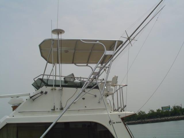 Atlantic Towers Top installed on an Egg Harbor Convertible boat with fishing outriggers and flybridge canopy.