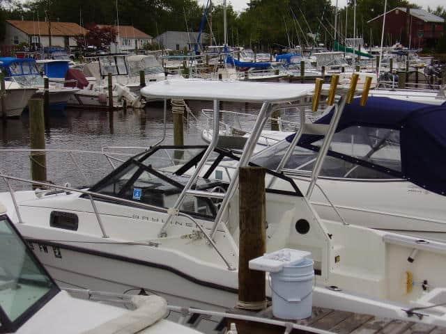 Atlantic Towers Top installed on a Trophy 2002 Walkaround boat at a marina with multiple boats docked.