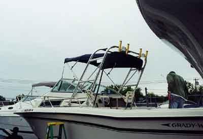 Atlantic Towers arch installed on a white Grady White 244 Explorer boat docked near a shore.