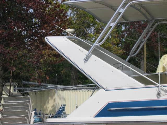 Atlantic Towers Top installed on a Wellcraft 43 San Remo double cabin boat shown docked on water.