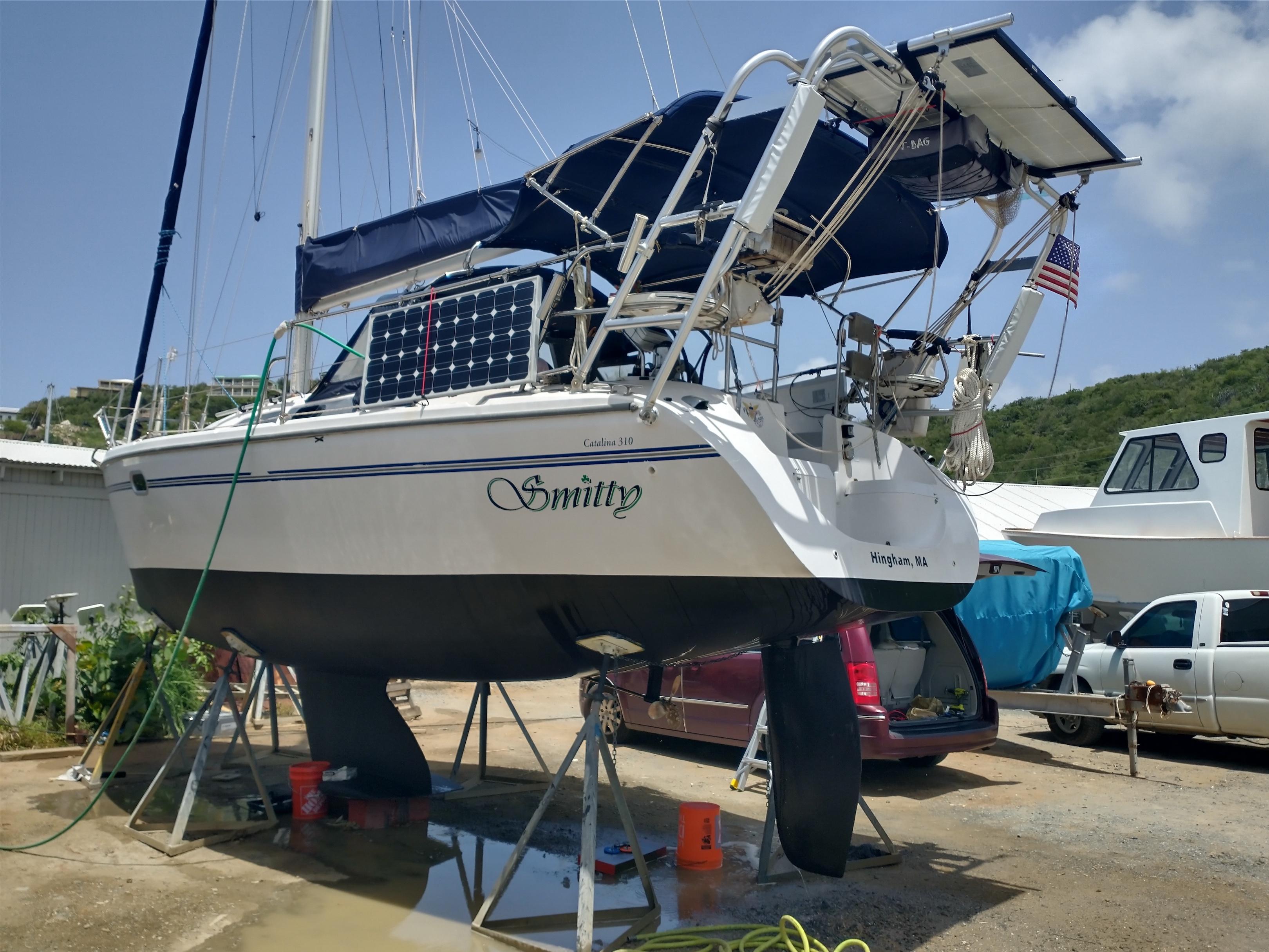 Sailboat named Smitty with a Catalina 310 hull on stands, equipped with an Atlantic Towers Arch holding solar panels.