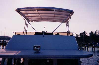 Atlantic Towers Top installed on a Gibson 42 boat, viewed from the rear with a serene waterfront background.