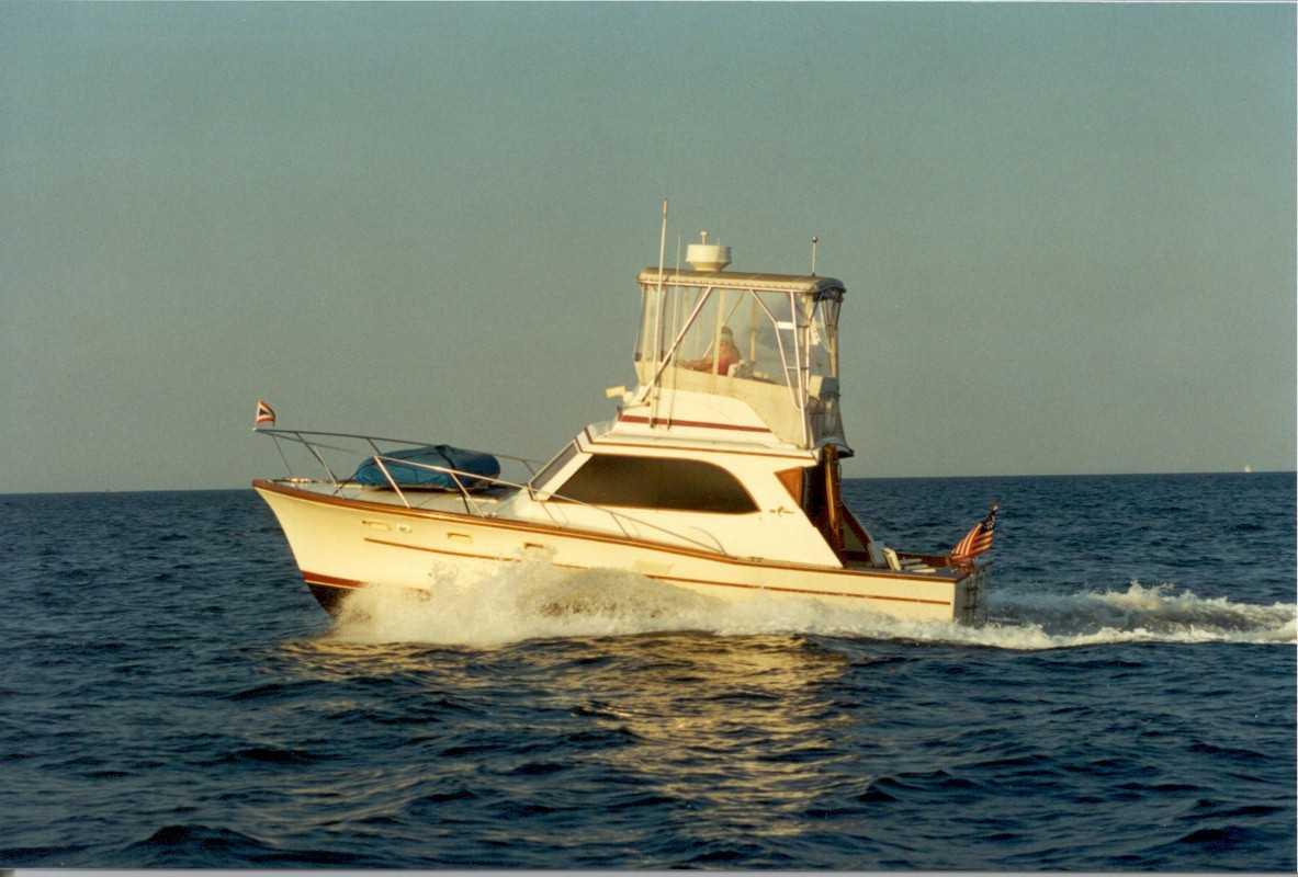 Egg Harbor 40 Sedan boat on water with Atlantic Towers Top installed on the flybridge enclosure