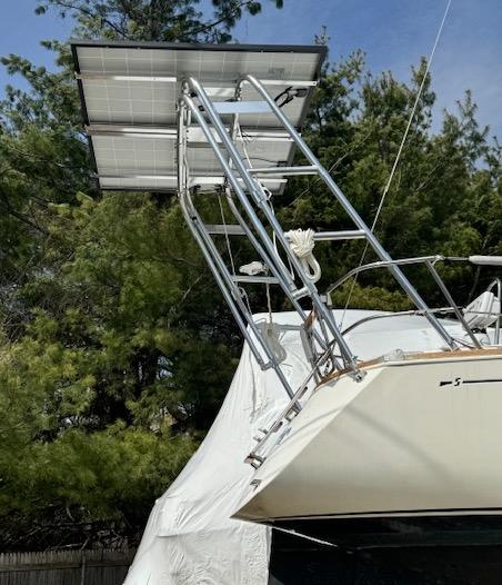 Atlantic Towers Arch installed on the stern of a Sabre boat with solar panels mounted on the arch under a clear sky.