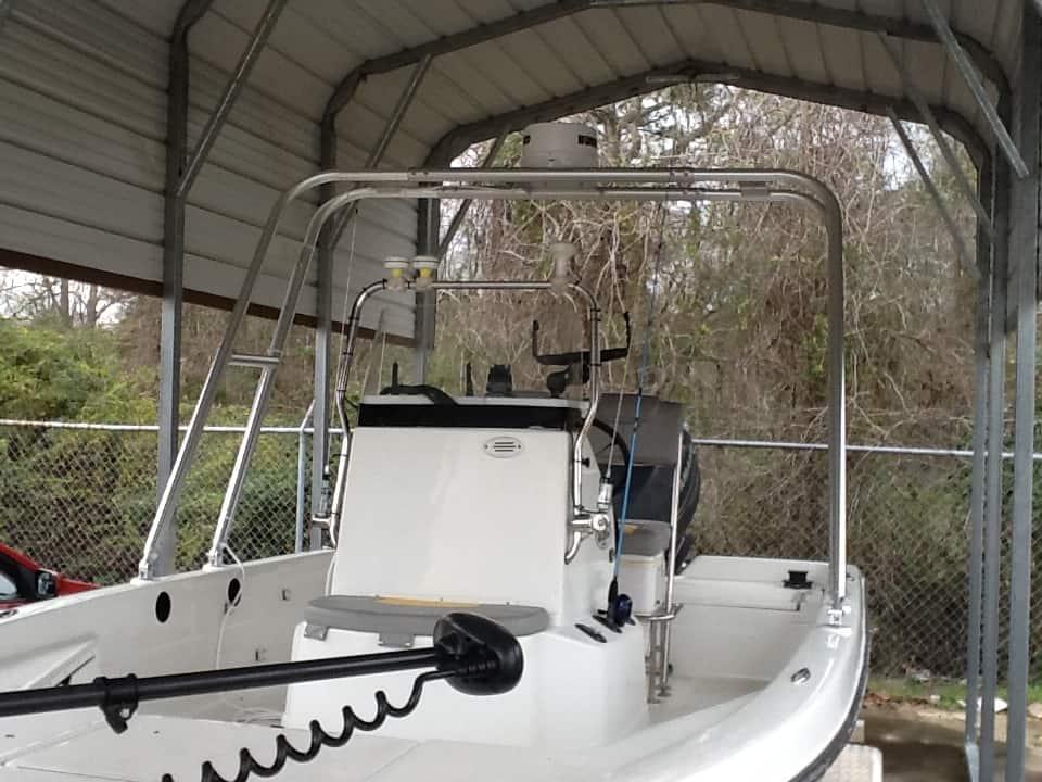 Skeeter ZX 20 Bay boat equipped with an Atlantic Towers Arch under a covered storage area with trees in background.