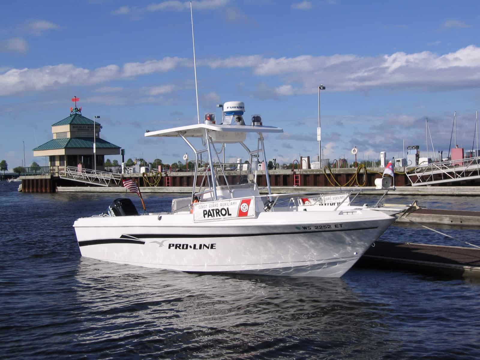 Atlantic Towers T-Top installed on a Pro Line 22 Console Sport boat docked near a marina under a blue sky.
