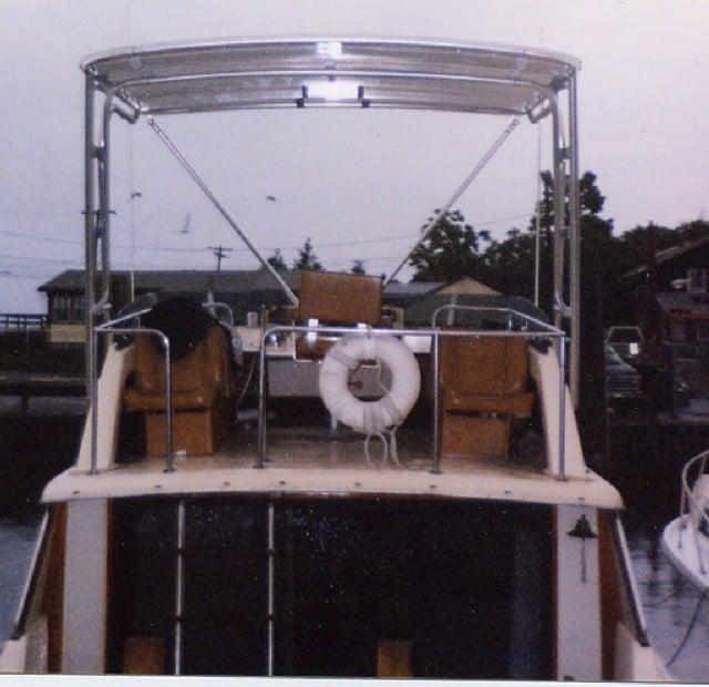 Alt text: Atlantic Towers Top installed on a Silverton 34 Convertible, showcasing the vessel's rear with seating and a life ring.
